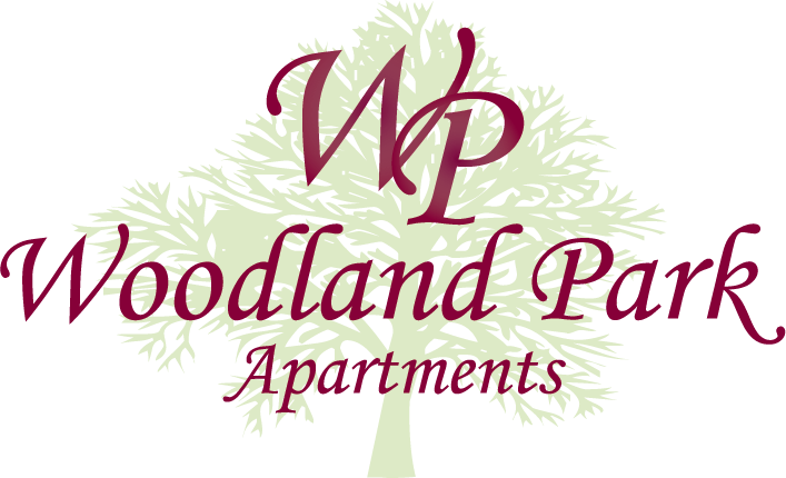 A logo for Woodland Park Apartments featuring a tree with the initials "Wp" in the center.